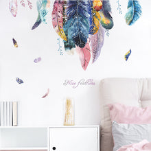 Load image into Gallery viewer, A wall decal of a flock of multicolored feathers displayed in a room setting.