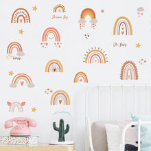 Load image into Gallery viewer, A variety of colorful wall decals featuring rainbows, stars, and love-related phrases, applied on a wall in a child's room setting.